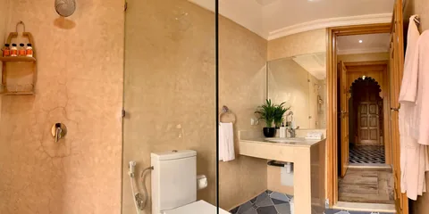 An en-suite bathroom with cedar joinery and robes