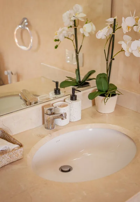 Orchids on the marble vanity of an en-suite bathroom