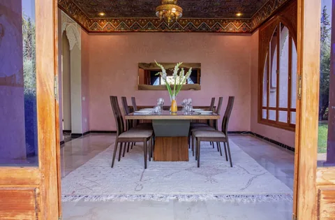 The formal dining room with carved arches and garden light
