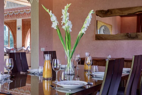 A table laid with glassware and white gladioli