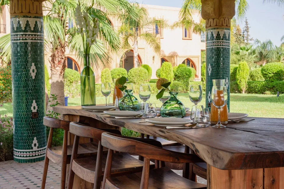 The dining table set beneath zellige columns in the garden loggia