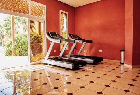 The air-conditioned gym with its bank of treadmills