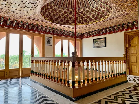 The carved cedar mezzanine gallery under the painted cupola