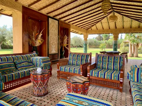 The garden majlis pavilion with woven ceiling and Moroccan sofas