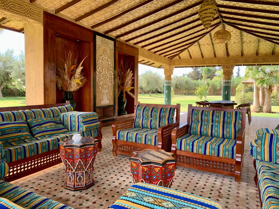 The garden majlis pavilion with woven ceiling and Moroccan sofas