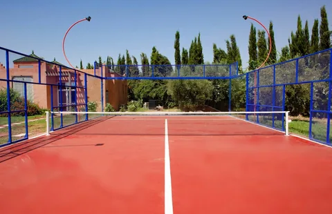 The private padel court at Dar Alameria, framed by cypresses