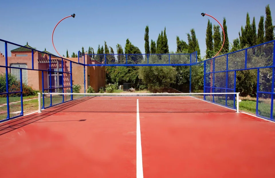 The private padel court at Dar Alameria, framed by cypresses