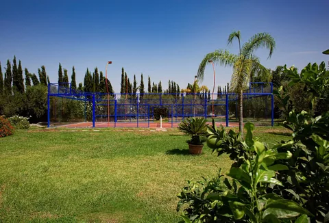 The padel court seen across the garden