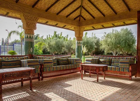 The pergola lounge overlooking the padel court and olive trees