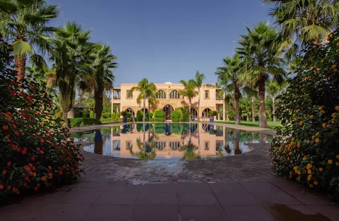 The villa reflected in the still pool at night