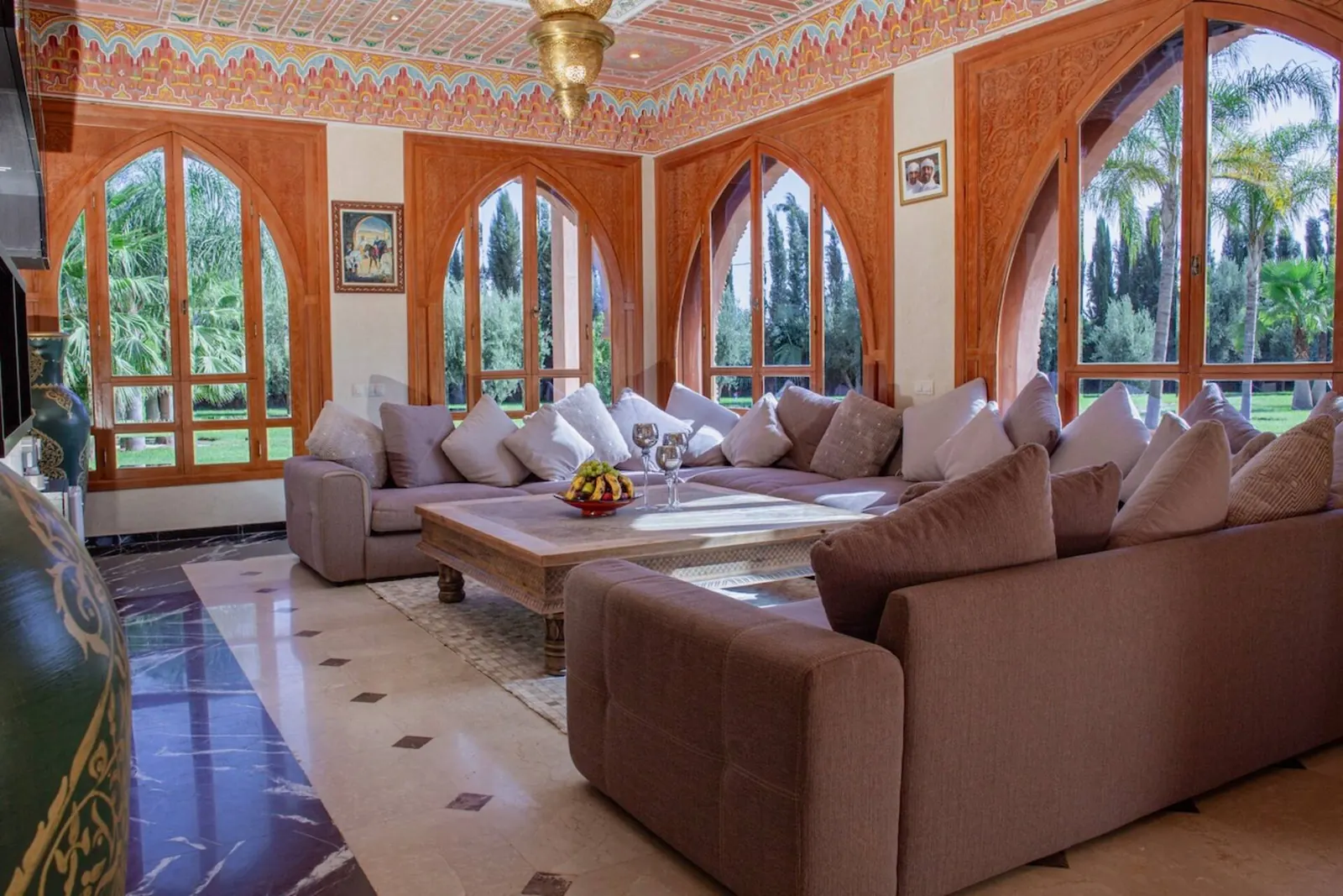 The grand Moroccan salon with carved arches and banquette seating