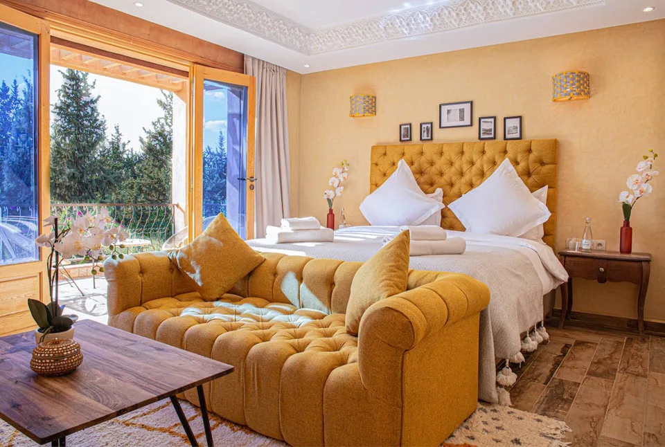 The gold suite with tufted headboard and garden terrace doors
