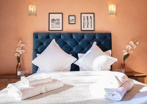 The navy suite with towels laid on white linen