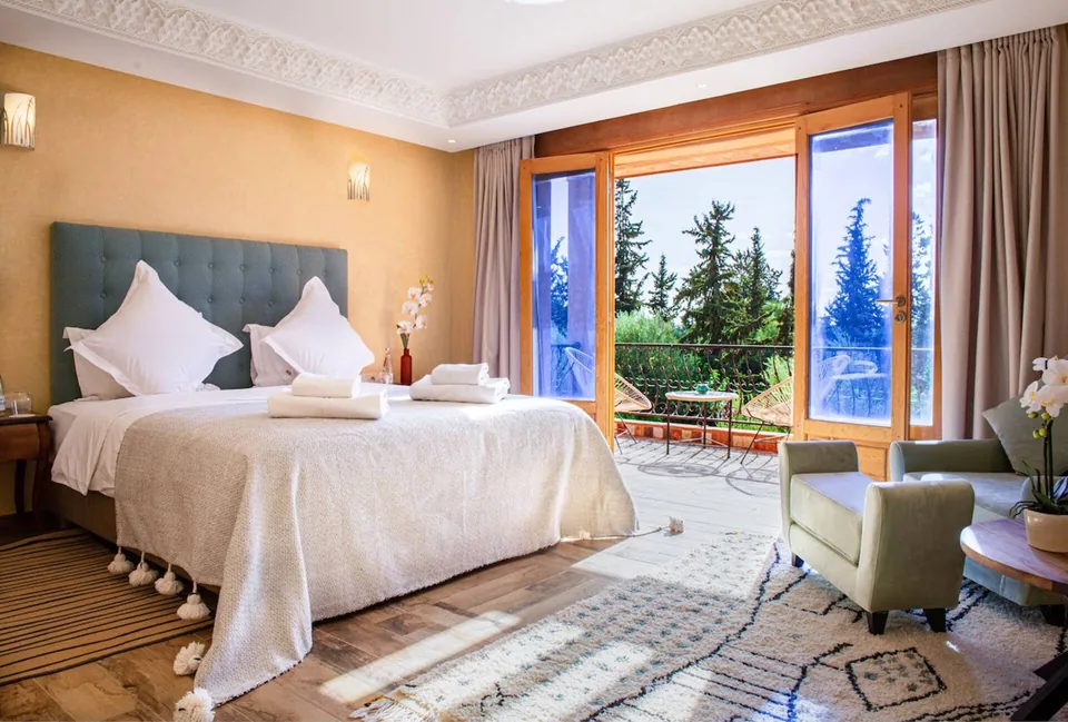 A teal-headboard suite with doors onto its private terrace