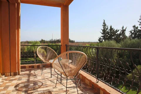 Two chairs on a suite terrace above the gardens